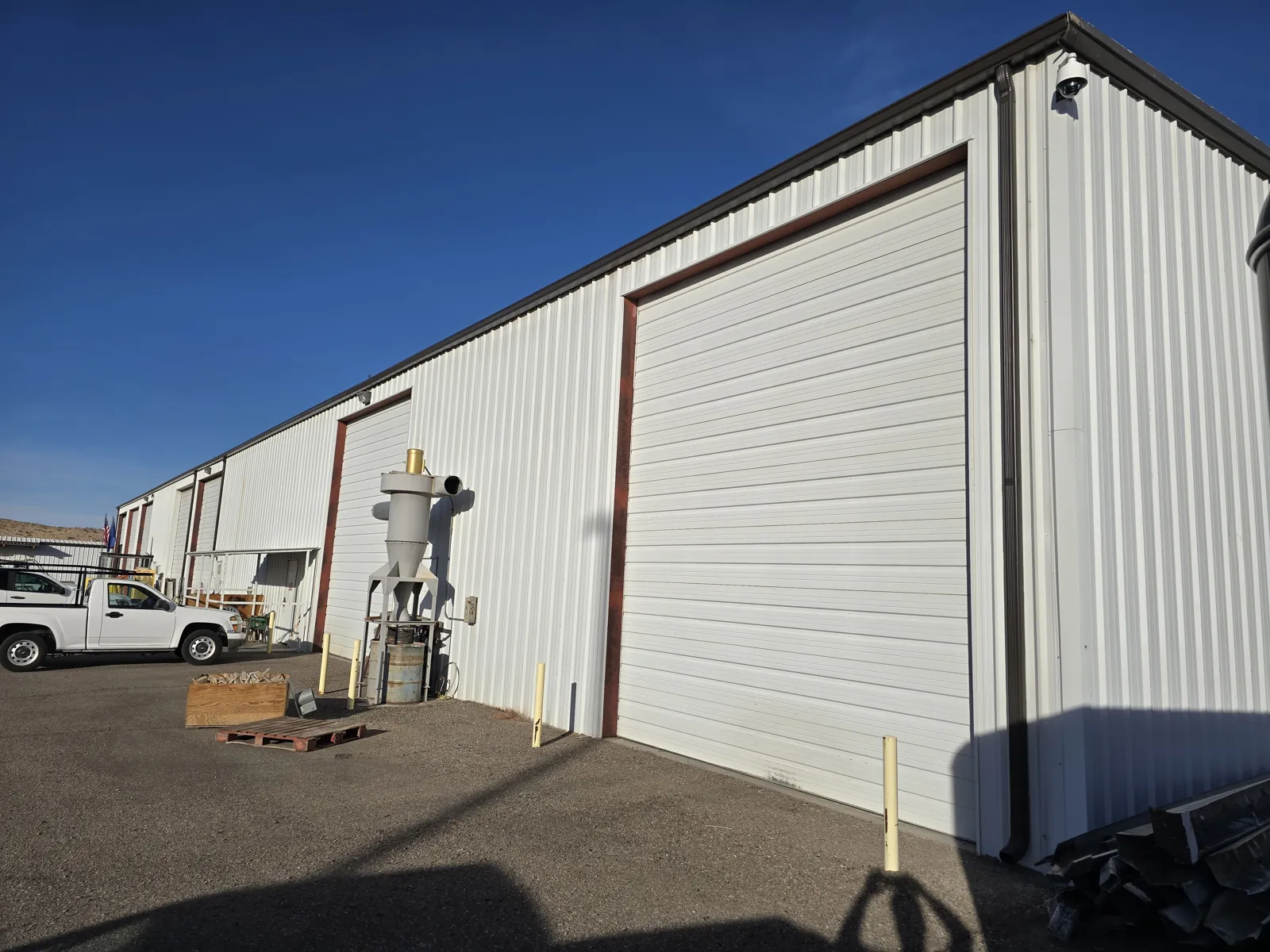 Seamless gutters and downspouts on a white metal commercial warehouse in Laughlin, NV
