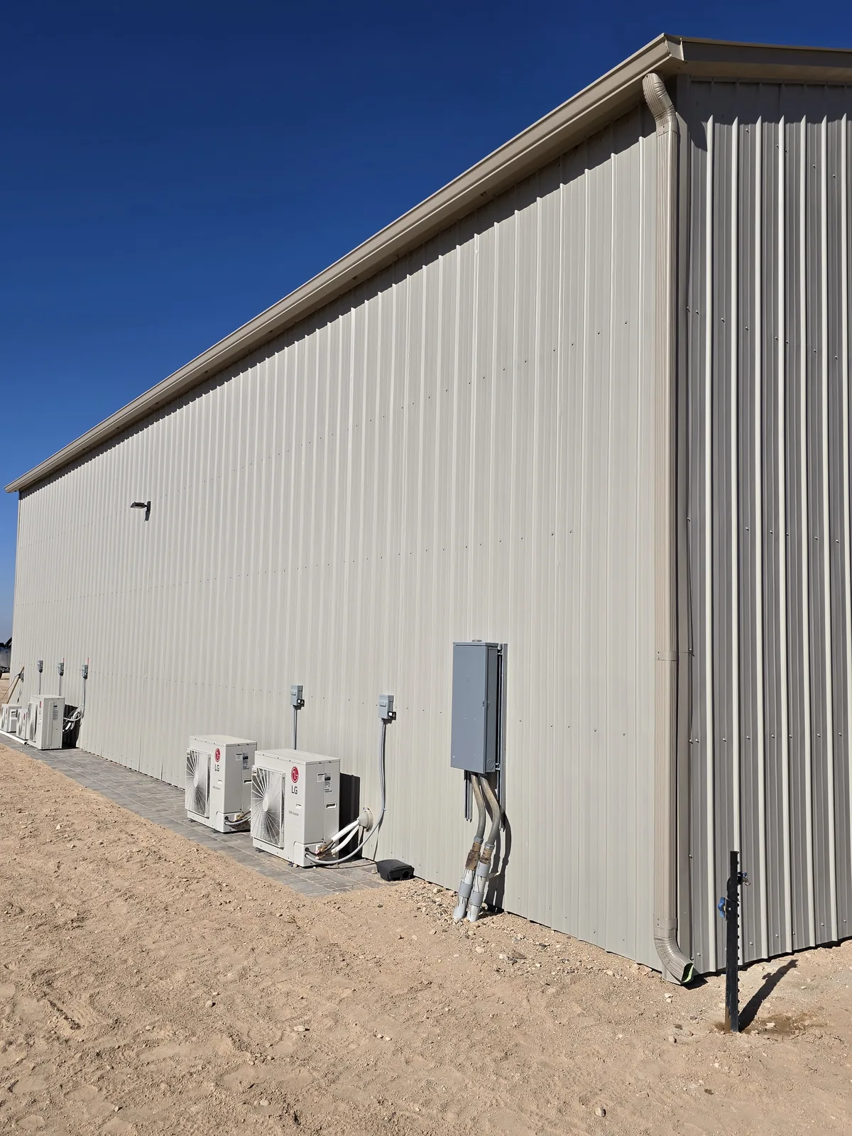 Tan seamless aluminum gutter and downspout on a tan metal commercial building in Las Vegas, NV