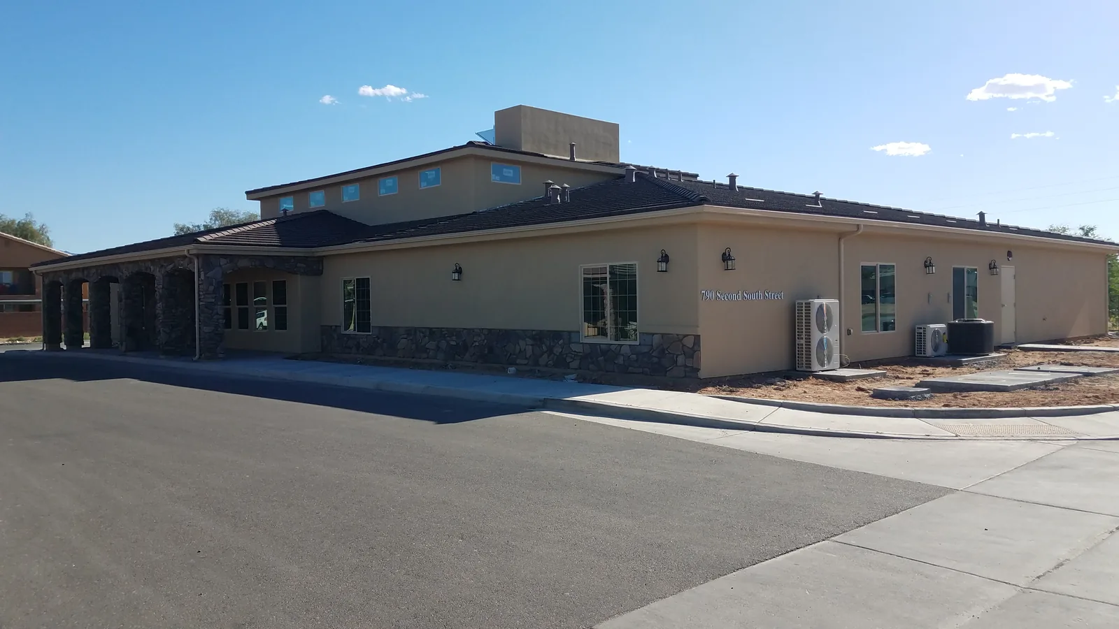 Seamless aluminum gutters on a stone-accent tile-roof office building at 790 Second South Street in Mesquite, NV