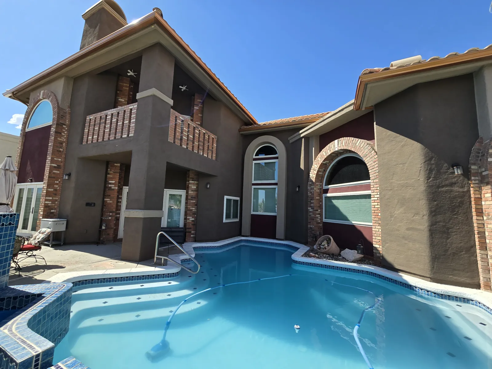 Copper gutters and downspout on a brown stucco desert home with a pool in Laughlin, NV