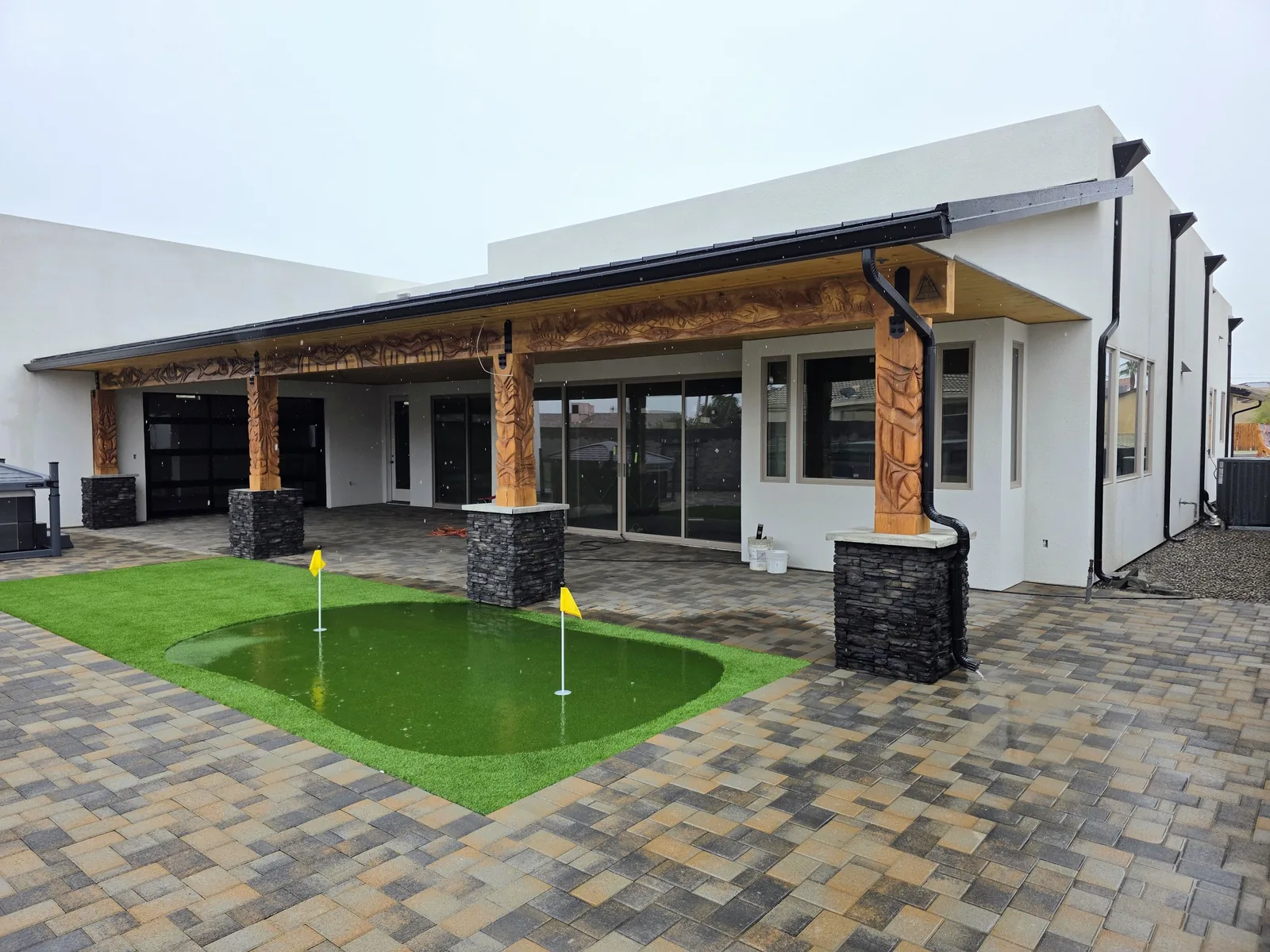 Black seamless aluminum gutter and downspout on a patio with putting green in Lake Havasu City, AZ