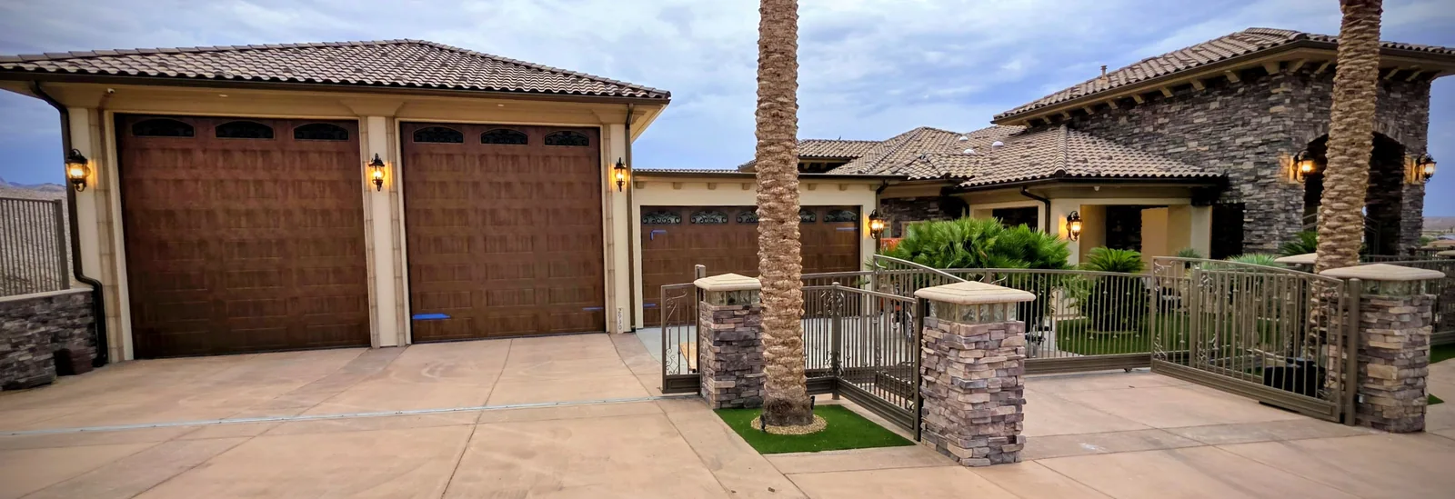 Bronze seamless aluminum downspouts on a wide stone luxury estate in Bullhead City, AZ