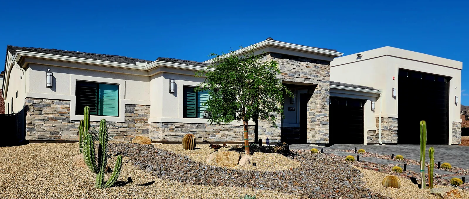 Seamless gutters and downspout on a single-story stucco and stone home in Lake Havasu City, AZ