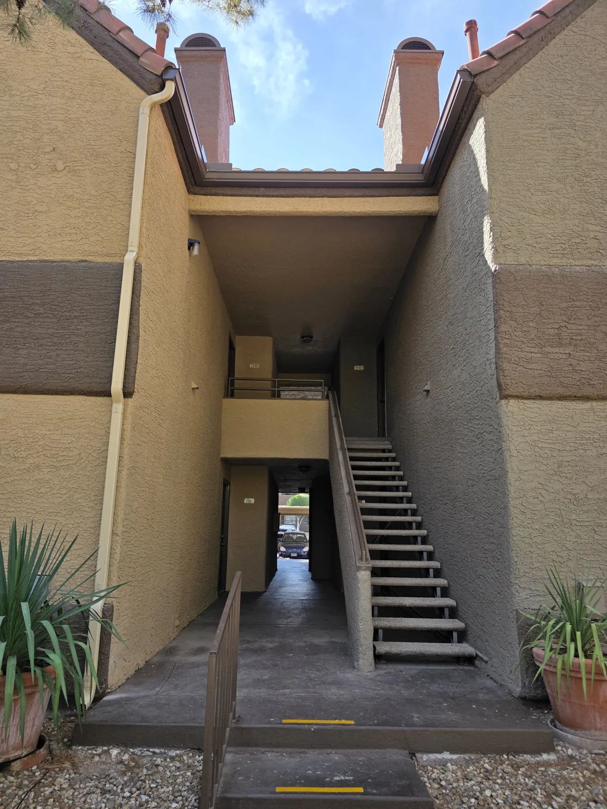 Repaired gutter and downspout along a condo stairwell in Lake Havasu City, AZ