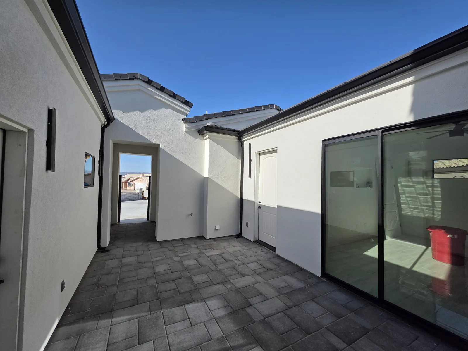 Seamless aluminum gutters and downspout on a paver courtyard breezeway in Fort Mohave, AZ
