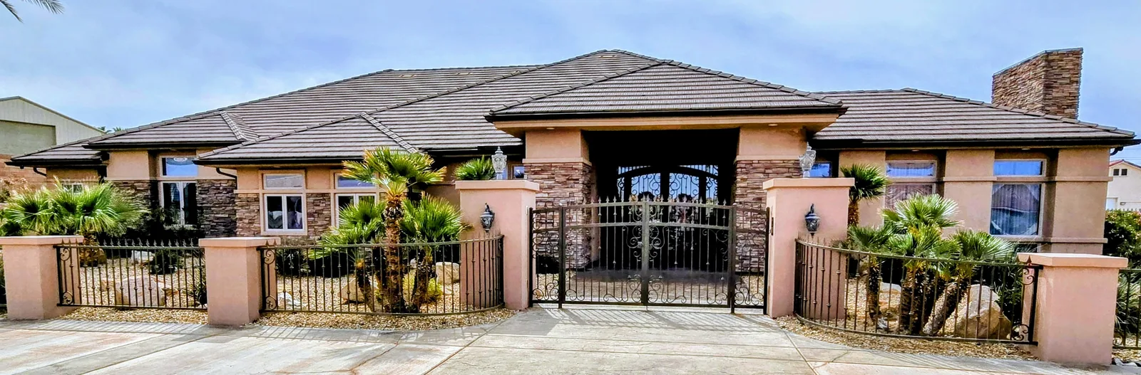 Seamless aluminum gutters on a gated stone-accent estate in Bullhead City, AZ