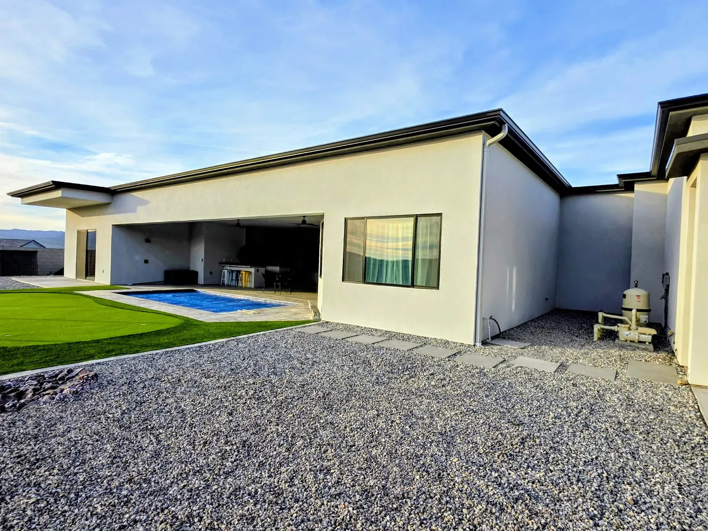 Dark fascia seamless aluminum gutter on a white modern single-story home with pool in Bullhead City, AZ