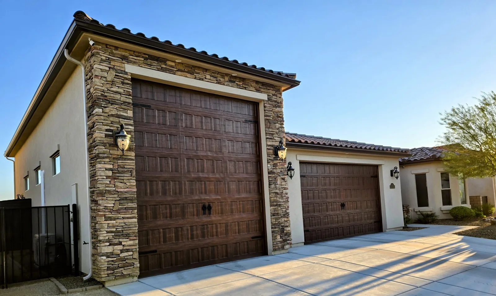 Seamless aluminum gutter on an RV-garage home with stacked-stone columns in Bullhead City, AZ