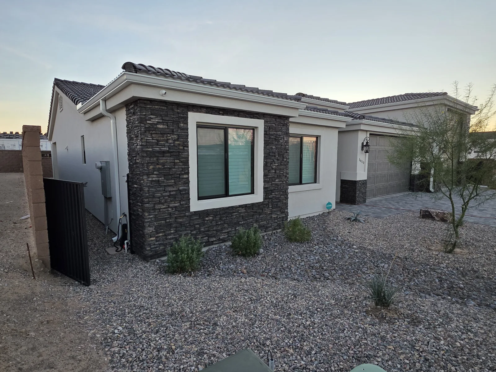 White seamless aluminum gutter and downspout on a stone-accent home in Lake Havasu City, AZ
