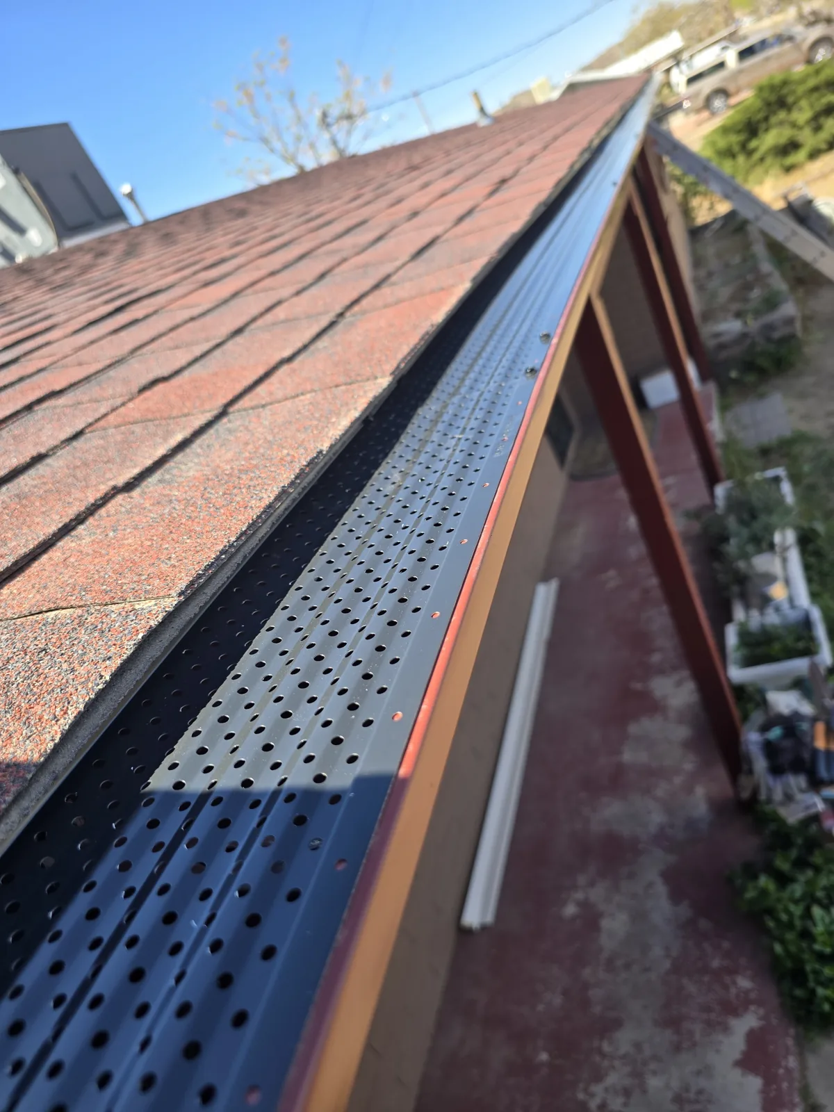 Perforated metal gutter guard along a shingle roof edge in Lake Havasu City, AZ