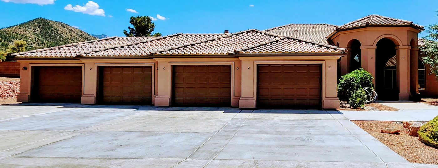 Seamless bronze aluminum rain gutters on a Mediterranean-style home with a tile roof in Kingman, AZ