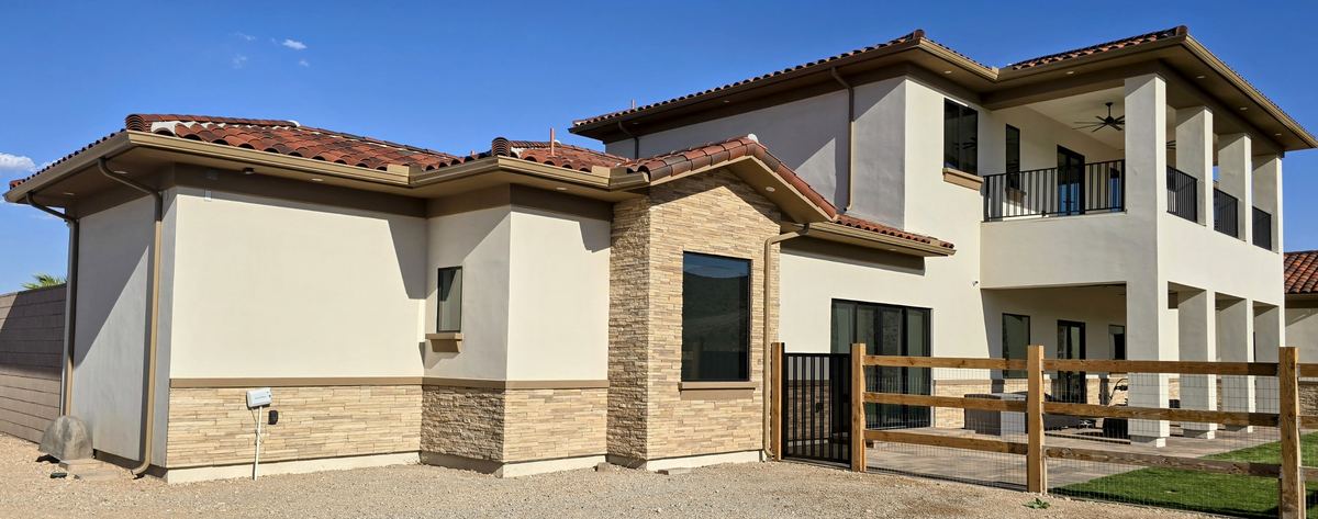 Complete seamless rain gutter and downspout system on a two-story home in Las Vegas, NV